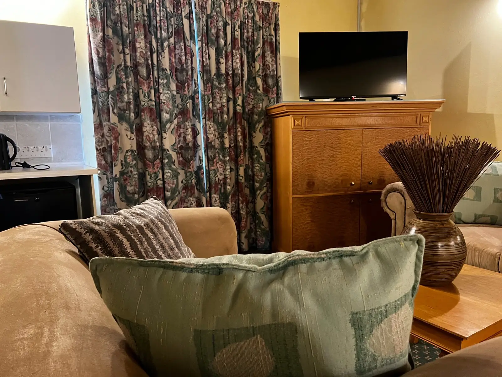 A comfortable sofa with scatter cushions in a suite lounge.