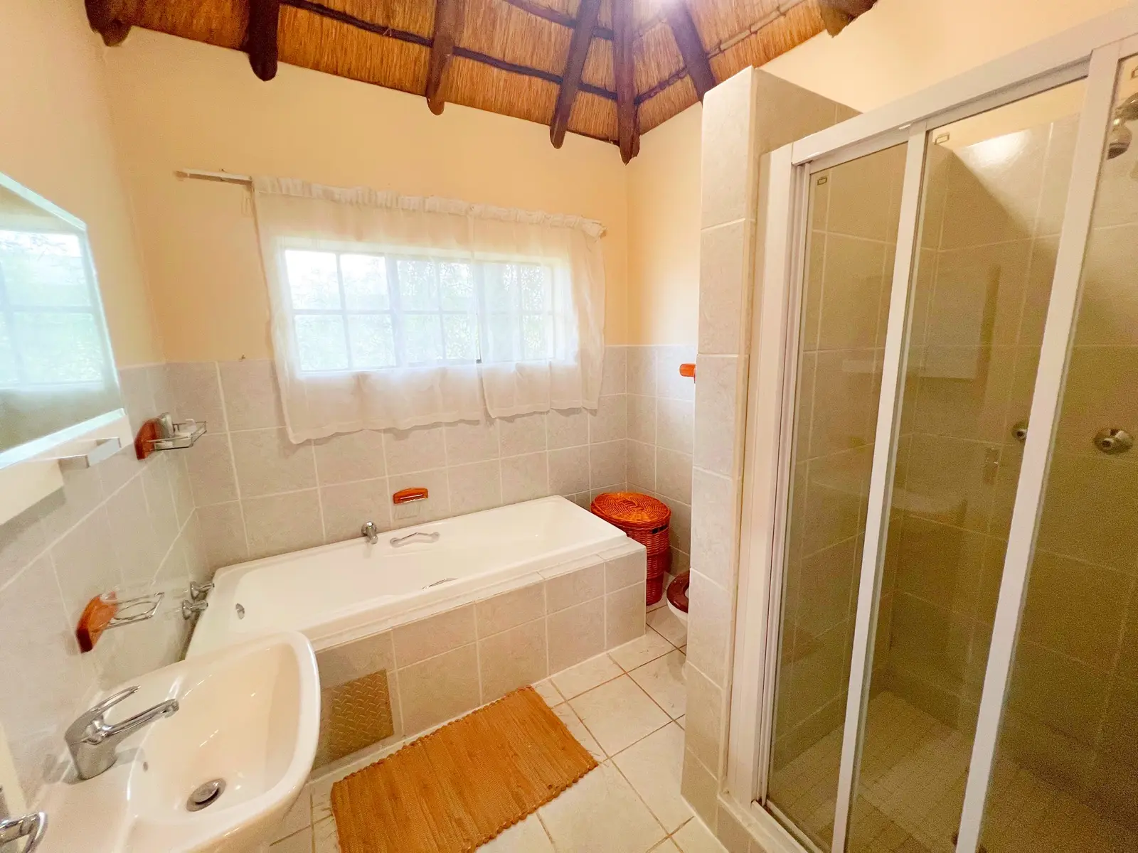 A bathroom with a deep bath and separate shower.