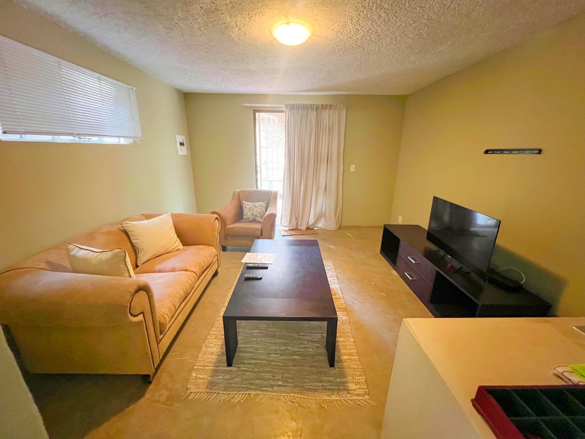 A private lounge with comfortable seating, television and a coffee table.